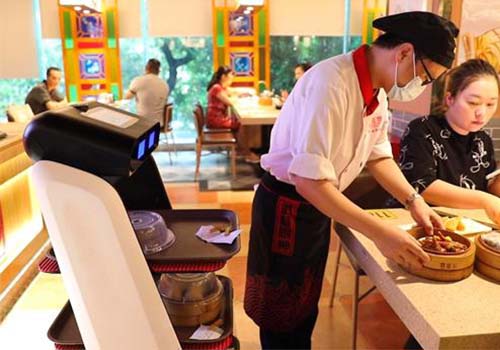 Why are the robot waiters so popular at restaurant?